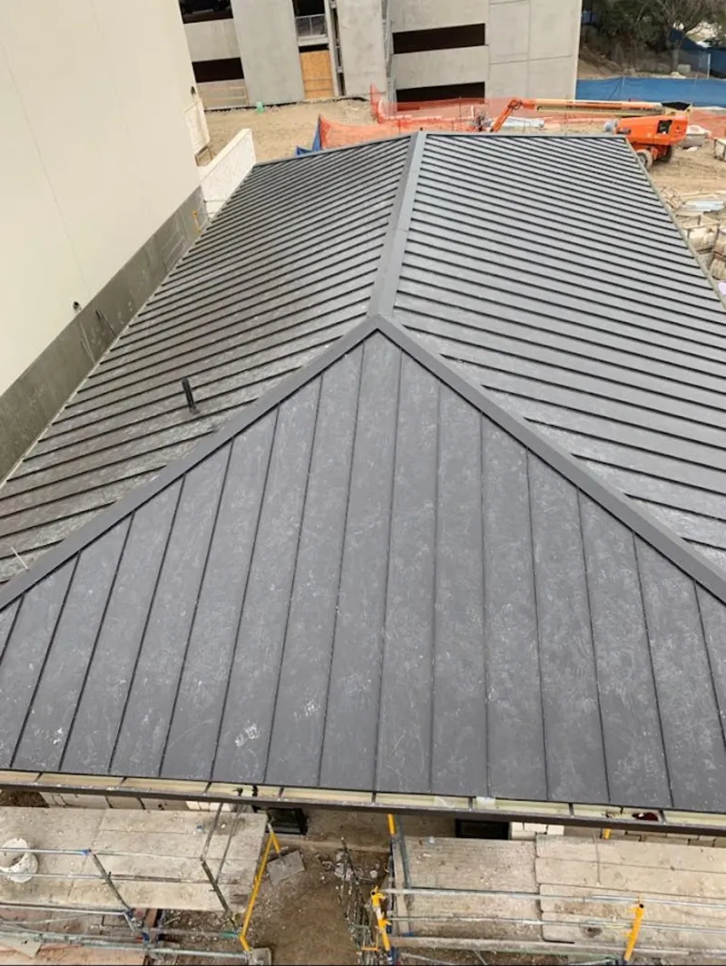 Commercial metal roof construction with crane equipment in West Long Branch