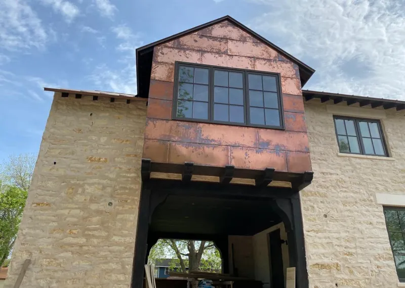 Copper metal panel facade on a stone building for Skylight Installation in West Long Branch