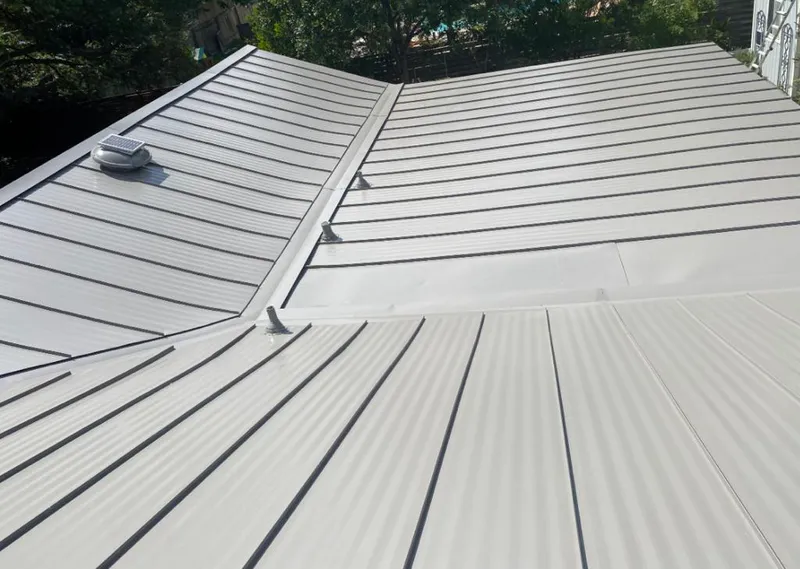 Solar attic fan installed on a metal roof for Roof Ventilation in West Long Branch